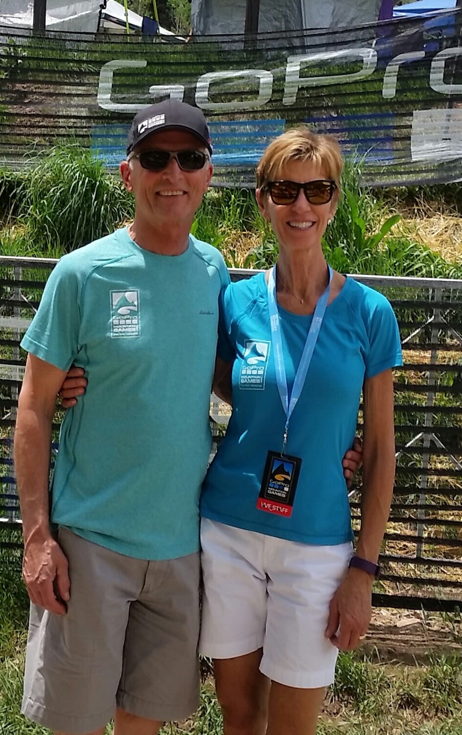 Debby and Harry Jasper smile while wearing t-shirts shorts and sunglasses on a nice summer day